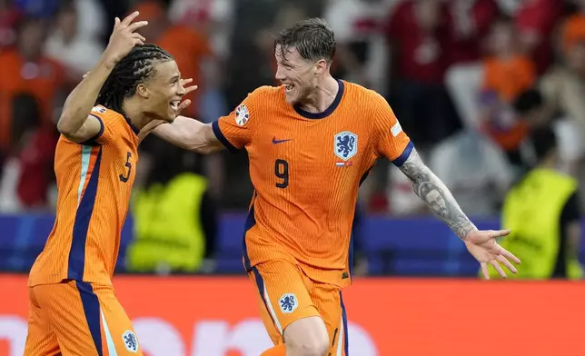 Wout Weghorst of the Netherlands, right, and Nathan Ake of the Netherlands celebrate after a quarterfinal match between the Netherlands and Turkey at the Euro 2024 soccer tournament in Berlin, Germany, Saturday, July 6, 2024. (AP Photo/Antonio Calanni)