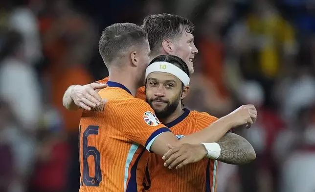 Stefan de Vrij of the Netherlands, left, with team-mates Memphis Depay of the Netherlands, 10, and Wout Weghorst of the Netherlands celebrate after the end of the quarterfinal match between the Netherlands and Turkey at the Euro 2024 soccer tournament in Berlin, Germany, Saturday, July 6, 2024. The Netherlands won the game 2-1. (AP Photo/Matthias Schrader)