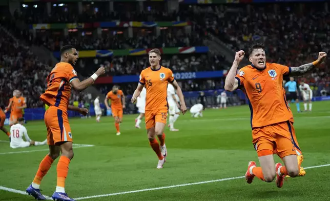 Wout Weghorst of the Netherlands, right, with teammates celebrates after an own goal by Turkey's Mert Muldur during a quarterfinal match between the Netherlands and Turkey at the Euro 2024 soccer tournament in Berlin, Germany, Saturday, July 6, 2024. (AP Photo/Ebrahim Noroozi)