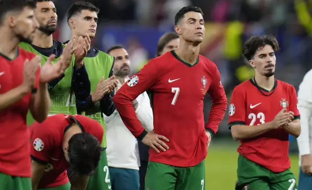 Portugal's Cristiano Ronaldo, center, reacts at the end of a quarter final match against France at the Euro 2024 soccer tournament in Hamburg, Germany, Friday, July 5, 2024. (AP Photo/Hassan Ammar)