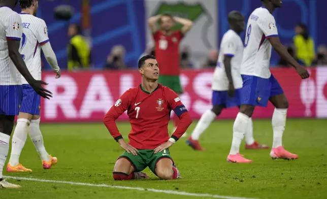 Portugal's Cristiano Ronaldo reacts after failing to score during a quarter final match between Portugal and France at the Euro 2024 soccer tournament in Hamburg, Germany, Friday, July 5, 2024. (AP Photo/Martin Meissner)