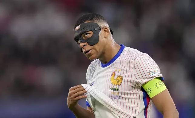 Kylian Mbappe of France reacts after missing an opportunity during a quarter final match between Portugal and France at the Euro 2024 soccer tournament in Hamburg, Germany, Friday, July 5, 2024. (AP Photo/Andreea Alexandru)