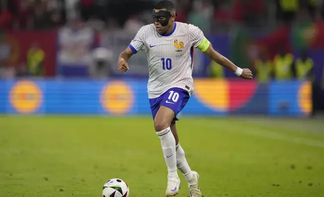 Kylian Mbappe of France controls the ball during a quarter final match between Portugal and France at the Euro 2024 soccer tournament in Hamburg, Germany, Friday, July 5, 2024. (AP Photo/Andreea Alexandru)