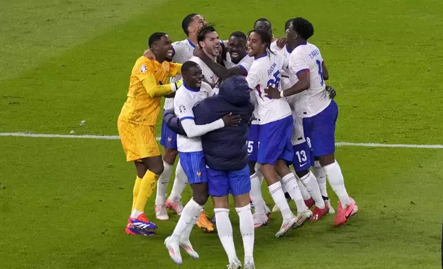 France players celebrate after penalty shootout against Portugal during a quarter final match at the Euro 2024 soccer tournament in Hamburg, Germany, Friday, July 5, 2024. (AP Photo/Darko Vojinovic)