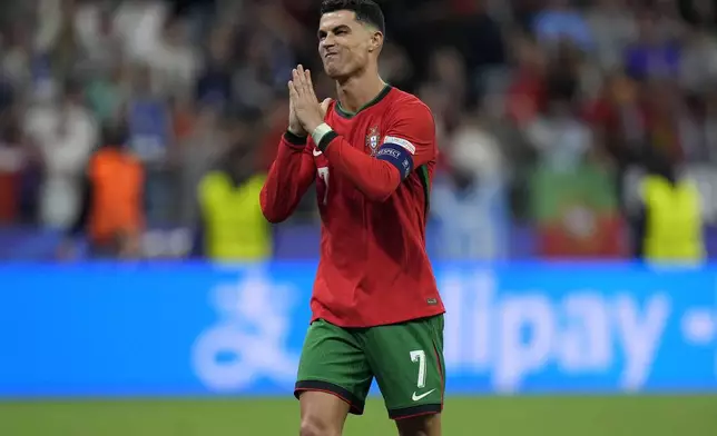 Portugal's Cristiano Ronaldo reacts after scoring in penalties shootouts during a round of sixteen match between Portugal and Slovenia at the Euro 2024 soccer tournament in Frankfurt, Germany, Monday, July 1, 2024. (AP Photo/Matthias Schrader)