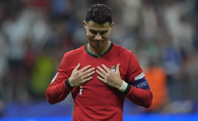 Portugal's Cristiano Ronaldo reacts after scoring in penalties shootouts during a round of sixteen match between Portugal and Slovenia at the Euro 2024 soccer tournament in Frankfurt, Germany, Monday, July 1, 2024. (AP Photo/Matthias Schrader)
