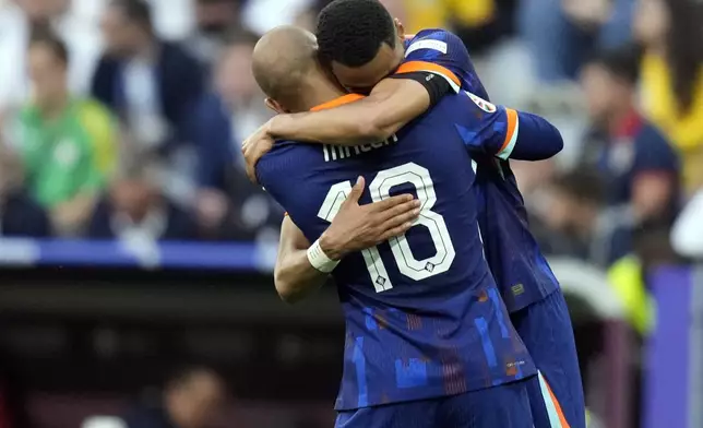 Netherlands' Donyell Malen (18) celebrates with Cody Gakpo after scoring their side's second goal during a round of sixteen match between Romania and the Netherlands at the Euro 2024 soccer tournament in Munich, Germany, Tuesday, July 2, 2024. (AP Photo/Ariel Schalit)