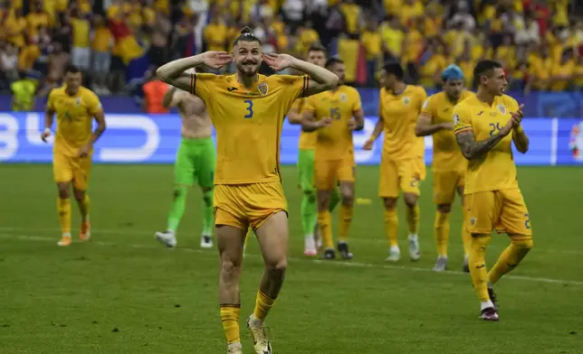 Romania's Radu Dragusin celebrates at the end of Group E match at the Euro 2024 soccer tournament against Slovakia in Frankfurt, Germany, Wednesday, June 26, 2024. The match ended in a 1-1 draw. (AP Photo/Themba Hadebe)