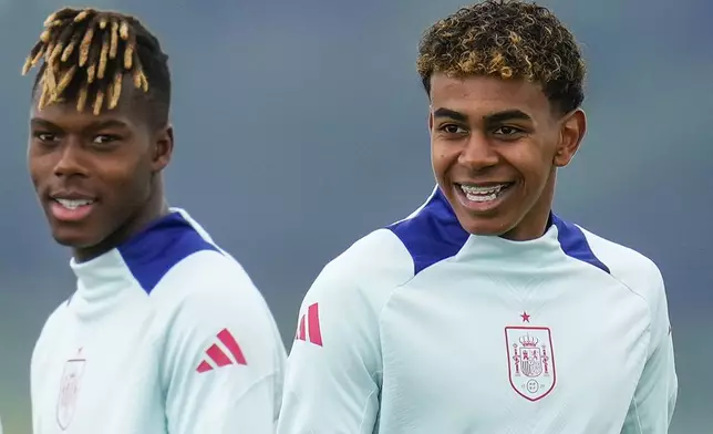 Spain's Nico Williams, left, and his teammate Lamine Yamal take part during a training session at their base camp in Donaueschingen, Germany, Sunday, June 23, 2024, ahead of their Group B soccer match against Albania at the Euro 2024 soccer tournament. (AP Photo/Manu Fernandez)