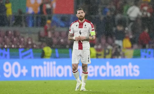 Georgia's Guram Kashia walks off the pitch after a round of sixteen match between Spain and Georgia at the Euro 2024 soccer tournament in Cologne, Germany, Sunday, June 30, 2024. (AP Photo/Martin Meissner)