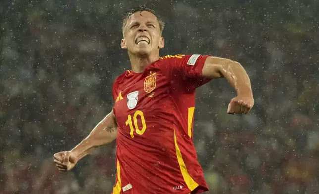 Spain's Dani Olmo celebrates after scoring his side's 4th goal against during a round of sixteen match at the Euro 2024 soccer tournament in Cologne, Germany, Sunday, June 30, 2024. (AP Photo/Frank Augstein)