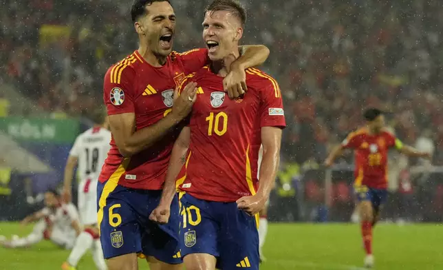 Spain's Dani Olmo, right, celebrates after scoring his side's 4th goal against during a round of sixteen match at the Euro 2024 soccer tournament in Cologne, Germany, Sunday, June 30, 2024. (AP Photo/Frank Augstein)