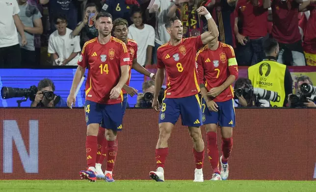 Spain's Fabian Ruiz (8) celebrates after scoring during a round of sixteen match between Spain and Georgia at the Euro 2024 soccer tournament in Cologne, Germany, Sunday, June 30, 2024. (AP Photo/Martin Meissner)