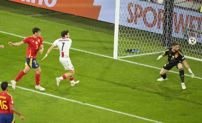 Spain's Robin Le Normand, left, scores an own goal during a round of sixteen match between Spain and Georgia at the Euro 2024 soccer tournament in Cologne, Germany, Sunday, June 30, 2024. (AP Photo/Andreea Alexandru)