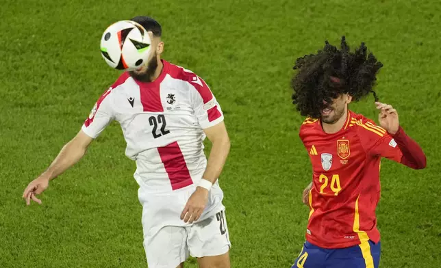 Georgia's Georges Mikautadze, left, fights for the ball with Spain's Marc Cucurella during a round of sixteen match between Spain and Georgia at the Euro 2024 soccer tournament in Cologne, Germany, Sunday, June 30, 2024. (AP Photo/Andreea Alexandru)