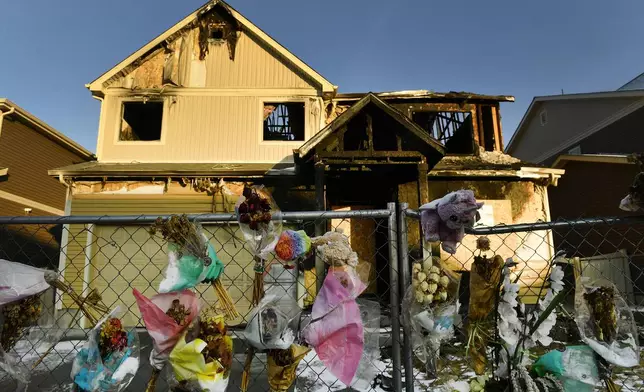 FILE - The house where five Senegalese immigrants were murdered in a fire is surrounded by old bouquets, stuffed animals and other remembrances, Jan. 27, 2021, in Denver. Kevin Bui has been sentenced to 60 years in prison, Tuesday, July 2, 2024, after pleading guilty to murder charges for starting the 2020 fire. (Helen H. Richardson/The Denver Post via AP, File)