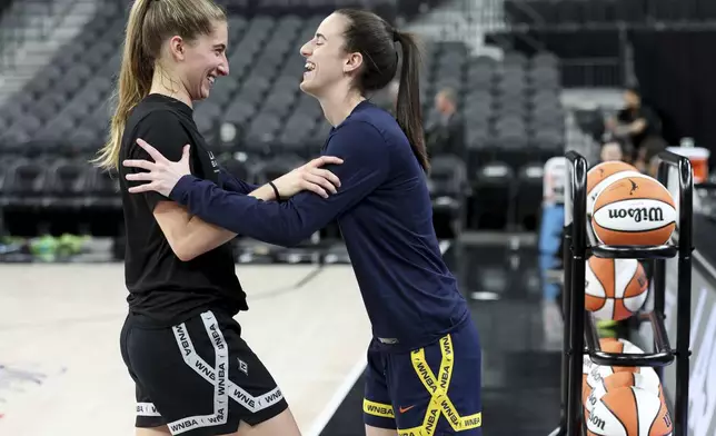 Las Vegas Aces guard Kate Martin, left, and Indiana Fever guard Caitlin Clark, former teammates at the University of Iowa, chat on the court prior to a WNBA basketball game Tuesday, July 2, 2024, in Las Vegas. (Ellen Schmidt/Las Vegas Review-Journal via AP)