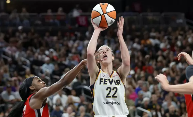 Indiana Fever guard Caitlin Clark (22) is fouled by Las Vegas Aces guard Jackie Young (0) during the second half of an WNBA basketball game Tuesday, July 2, 2024, in Las Vegas. (Steve Marcus/Las Vegas Sun via AP)