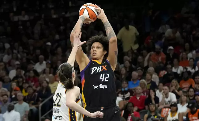 Phoenix Mercury center Brittney Griner (42) looks to shoot over Indiana Fever guard Caitlin Clark (22) during the second half of a WNBA basketball game Sunday, June 30, 2024, in Phoenix. (AP Photo/Ross D. Franklin)