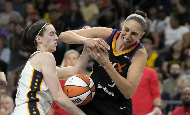 Phoenix Mercury guard Diana Taurasi, right, is fouled by Indiana Fever guard Caitlin Clark, left, during the second half of a WNBA basketball game Sunday, June 30, 2024, in Phoenix. (AP Photo/Ross D. Franklin)