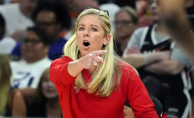 Indiana Fever head coach Christie Sides shouts instructions to her players during the first half of a WNBA basketball game against the Phoenix Mercury, Sunday, June 30, 2024, in Phoenix. (AP Photo/Ross D. Franklin)
