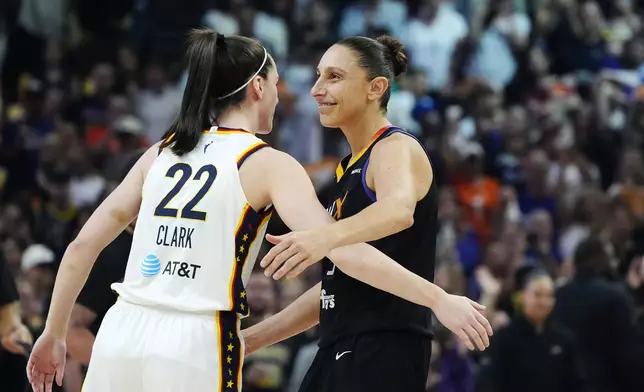 Indiana Fever guard Caitlin Clark (22) gets a hug from Phoenix Mercury guard Diana Taurasi, right, prior to a WNBA basketball game, Sunday, June 30, 2024, in Phoenix. (AP Photo/Ross D. Franklin)