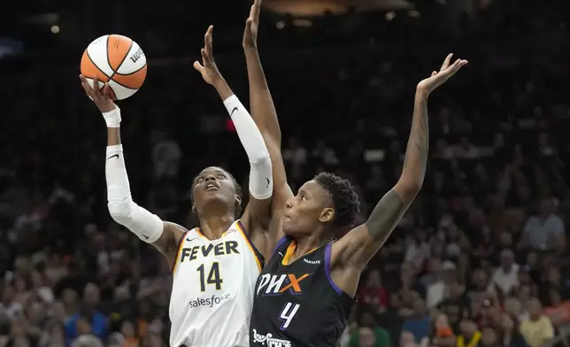 Indiana Fever center Temi Fagbenle (14) looks to shoot against Phoenix Mercury forward Natasha Mack (4) during the first half of a WNBA basketball game Sunday, June 30, 2024, in Phoenix. (AP Photo/Ross D. Franklin)