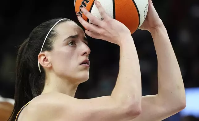 Indiana Fever guard Caitlin Clark looks to shoot a free throw during the first half of a WNBA basketball game against the Phoenix Mercury, Sunday, June 30, 2024, in Phoenix. (AP Photo/Ross D. Franklin)