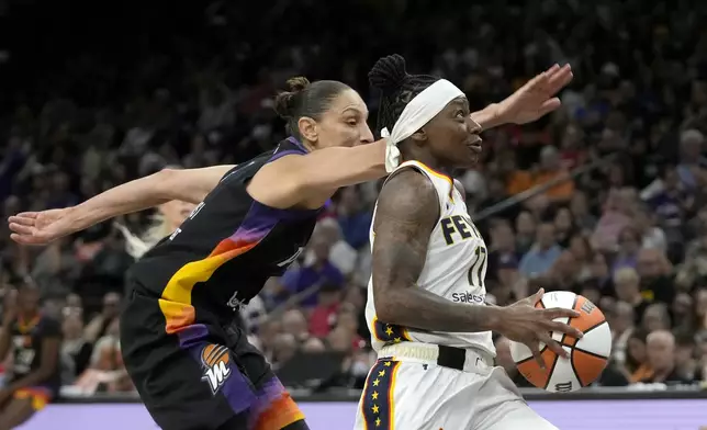 Indiana Fever guard Erica Wheeler, right, drives past Phoenix Mercury guard Diana Taurasi, left, during the first half of a WNBA basketball game Sunday, June 30, 2024, in Phoenix. (AP Photo/Ross D. Franklin)