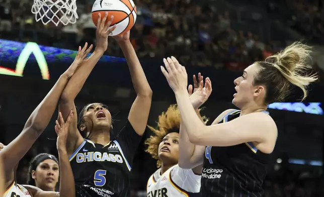 Chicago Sky forward Angel Reese (5) and guard Marina Mabrey (4) battle Indiana Fever forward Aliyah Boston (7) and forward NaLyssa Smith (1) for a rebound during a WNBA basketball game, Sunday, June 23, 2024, in Chicago. (Eileen T. Meslar/Chicago Tribune via AP)