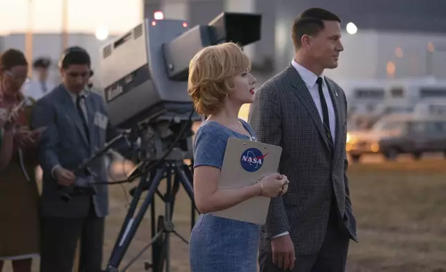 This image released by Apple TV+ shows Scarlett Johansson, center, an Channing Tatum, right, in a scene from "Fly Me to the Moon. (Dan McFadden/Apple TV+ via AP)