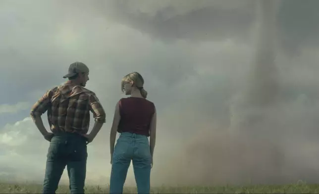 This image released by Universal Pictures shows Glen Powell, left, and Daisy Edgar-Jones in a scene from "Twisters." (Universal Pictures via AP)