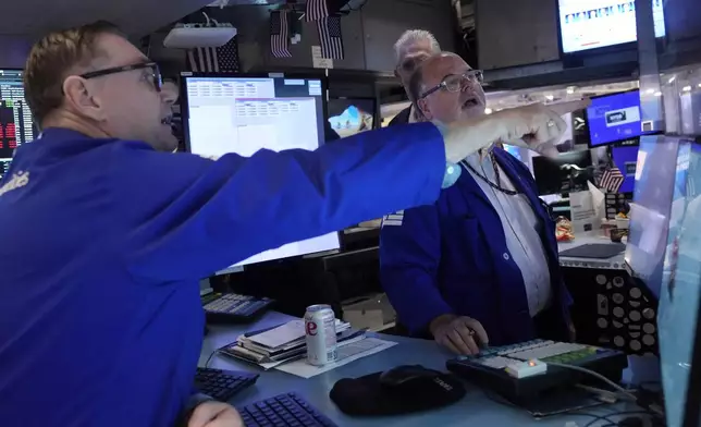 Specialists Patrick King, left, and Douglas Johnson work on the floor of the New York Stock Exchange, Monday, July 22, 2024. U.S. stocks are climbing Monday and clawing back some of the losses from their worst week since April. (AP Photo/Richard Drew)