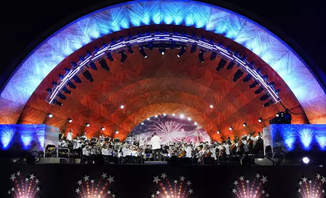 The Boston Pops Esplanade Orchestra performs during the Boston Pops Fireworks Spectacular at the Hatch Memorial Shell on the Esplanade in Boston, Thursday, July 4, 2024. (AP Photo/Michael Dwyer)