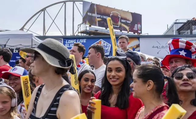 People wait for the start of Nathan's Famous Fourth of July hot dog eating contest, Thursday, July 4, 2024 at Coney Island in the Brooklyn borough of New York. (AP Photo/Julia Nikhinson)