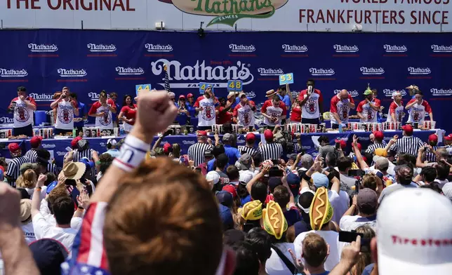 Competitive eaters participate in the men's division in Nathan's Famous Fourth of July hot dog eating contest, Thursday, July 4, 2024, at Coney Island in the Brooklyn borough of New York. (AP Photo/Julia Nikhinson)