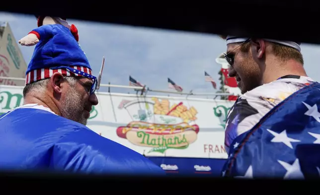 People watch Nathan's Famous Fourth of July hot dog eating contest, Thursday, July 4, 2024, at Coney Island in the Brooklyn borough of New York. (AP Photo/Julia Nikhinson)