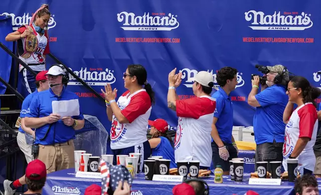 Miki Sudo, top left, arrives at the Nathan's Famous Fourth of July hot dog eating contest, Thursday, July 4, 2024, at Coney Island in the Brooklyn borough of New York.. (AP Photo/Julia Nikhinson)