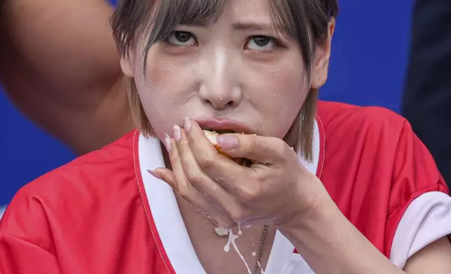 Mayoi Ebihara competes in the women's division of Nathan's Famous Fourth of July hot dog eating contest, Thursday, July 4, 2024, at Coney Island in the Brooklyn borough of New York. (AP Photo/Julia Nikhinson)