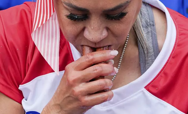 Miki Sudo competes in the women's division of the Nathan's Famous Fourth of July hot dog eating contest, Thursday, July 4, 2024, at Coney Island in the Brooklyn borough of New York. Sudo ate a record 51 hot dogs. (AP Photo/Julia Nikhinson)
