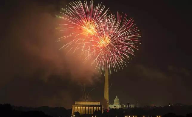 Fireworks burst above the National Mall, and from left, the Lincoln Memorial, Washington Monument and the U.S. Capitol building during Independence Day celebrations on Thursday, July 4, 2024, in Washington. (AP Photo/Mark Schiefelbein)