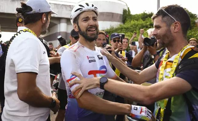 Stage winner France's Anthony Turgis celebrates after the ninth stage of the Tour de France cycling race over 199 kilometers (123.7 miles) with start and finish in Troyes, France, Sunday, July 7, 2024. (Molly Darlington/Pool Photo via AP)