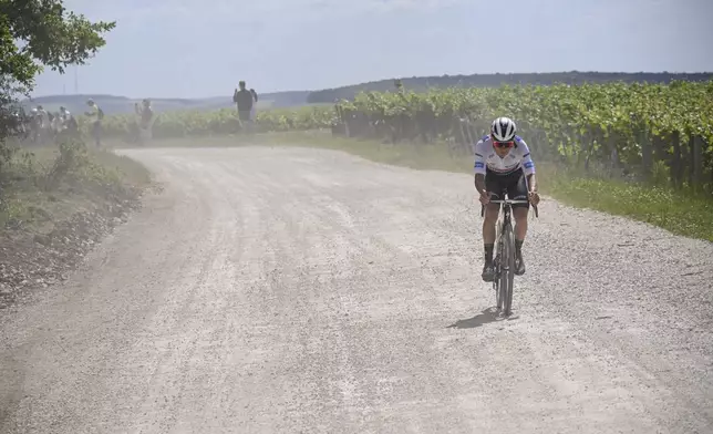 Belgium's Remco Evenepoel rides breakaway on a gravel road during the ninth stage of the Tour de France cycling race over 199 kilometers (123.7 miles) with start and finish in Troyes, France, Sunday, July 7, 2024. (Bernard Papon/Pool Photo via AP)