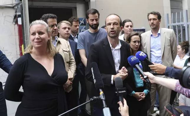 Far-left France Unbowed party member Manuel Bompard, with Mathilde Panot at left, speaks to reporters outside the party headquarters Monday, July 8, 2024 in Paris. French President Emmanuel Macron rejected the resignation of Prime Minister Gabriel Attal Monday, in the wake of a chaotic election result that left neither left, right, nor center with a majority in the National Assembly. (AP Photo/Aurelien Morissard)