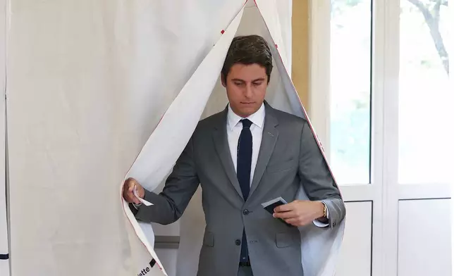 French Prime Minister Gabriel Attal, leaves the polling booth before voting for the second round of the legislative election, Sunday, July 7, 2024 in Vanves, outside Paris. Voting has begun in mainland France on Sunday in pivotal runoff elections that could hand a historic victory to Marine Le Pen's far-right National Rally and its inward-looking, anti-immigrant vision — or produce a hung parliament and years of political deadlock. (Alain Jocard, Pool via AP)