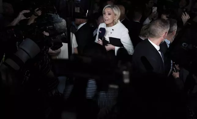 Far-right National Rally party leader Marine Le Pen answers reporters after the second round of the legislative election, Sunday, July 7, 2024, at the party election night headquarters in Paris. A coalition on the left that came together unexpectedly ahead of France's snap elections won the most parliamentary seats in the vote, according to polling projections Sunday. The surprise projections put President Emmanuel Macron's centrist alliance in second and the far right in third. (AP Photo/Louise Delmotte)