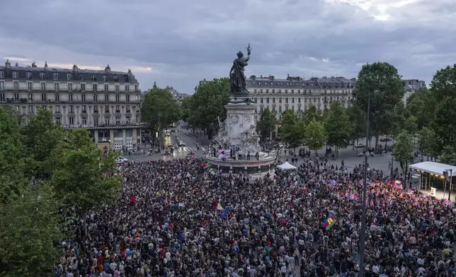 People gather at Republique square to protest the far-right National Rally, which came out strongly ahead in first-round legislative elections, Sunday, June 30, 2024 in Paris. France's high-stakes legislative elections propelled the far-right National Rally to a strong but not decisive lead in the first-round vote Sunday, polling agencies projected, dealing another slap to centrist President Emmanuel Macron. (AP Photo/Louise Delmotte)