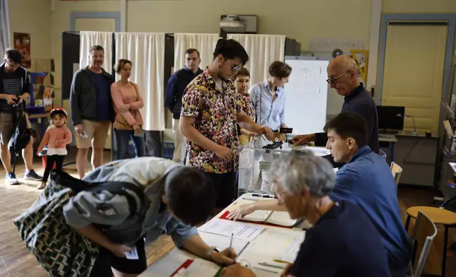 A man casts his ballot in the second round of the legislative elections, Sunday, July 7, 2024 in Rennes, western France. (AP Photo/Jeremias Gonzalez)