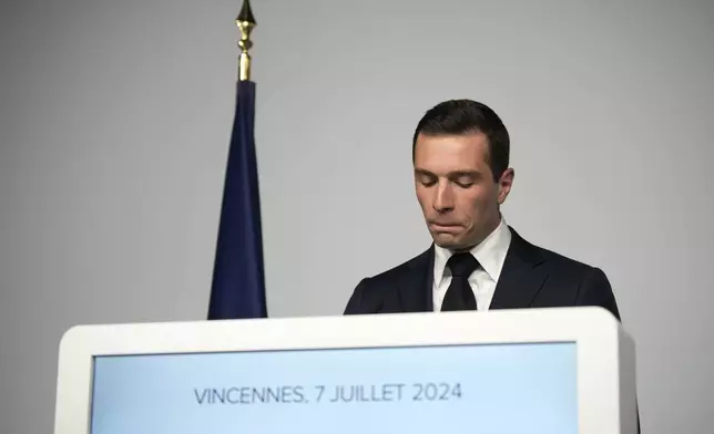 Far-right National Rally party president Jordan Bardella reacts as he delivers a speech after the second round of the legislative election, Sunday, July 7, 2024 at their election night headquarters in Paris. A coalition on the left that came together unexpectedly ahead of France's snap elections won the most parliamentary seats in the vote, according to polling projections Sunday. The surprise projections put President Emmanuel Macron's centrist alliance in second and the far right in third. (AP Photo/Louise Delmotte)