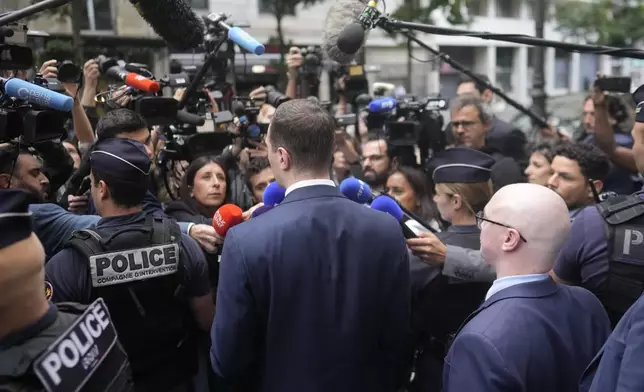 Jordan Bardella, president of the far-right National Rally party, answers reporters as he arrives at the party headquarters, Monday, July 1, 2024 in Paris. France's National Rally surged into the lead in the first round of legislative elections, according to results released early Monday, bringing the far-right party to the brink of power and dealing a major blow to President Emmanuel Macron's centrists in an election that could set the country, and Europe, on a starkly different course. (AP Photo/Thibault Camus)